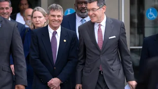A judge permanently dismisses former Olympian's Reflecting Pool charges